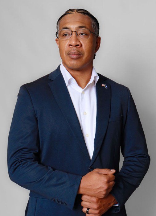 Studio portrait of Jason M. Payne in a navy suit.