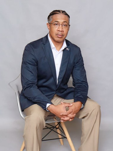 Jason M. Payne seated, three-quarter view.